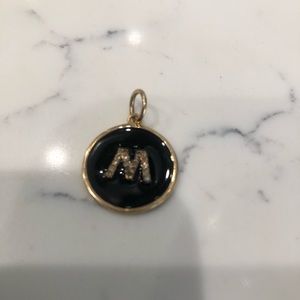 Enamel and diamond “m” charm